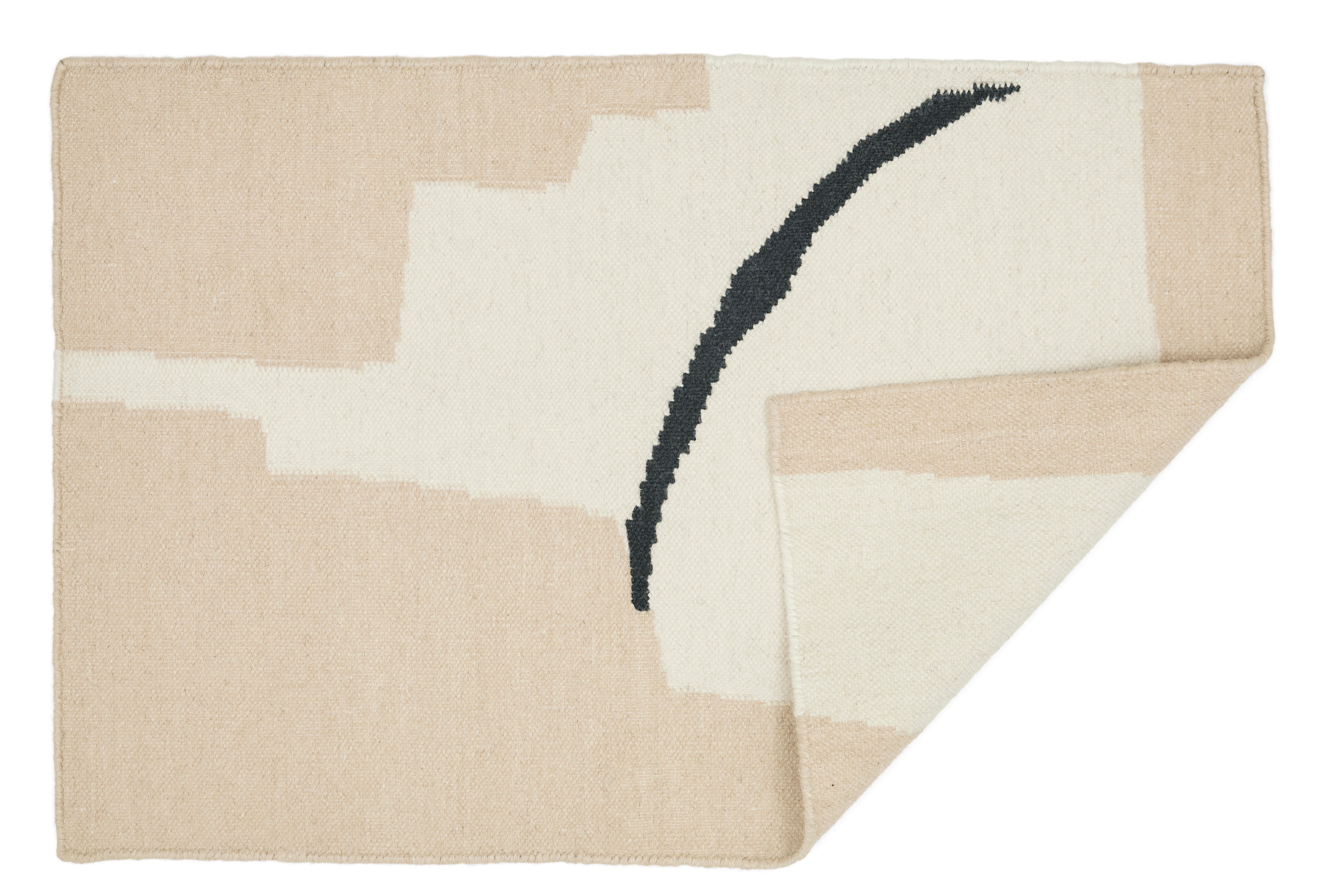A 100% wool yarn flat weave rug from Cold Picnic. An abstract design featuring cream with tan and black. Available in sizes 2x3' 4x6', 6x9'.