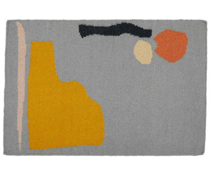 A 100% wool yarn flat weave rug from Cold Picnic. An abstract design featuring blue/grey with yellow and black